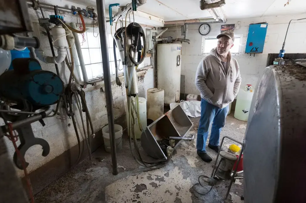 Bruce Drinkman looks around the milk house that needs to be cleaned and painted. Image by Mark Hoffman. United States, 2019.