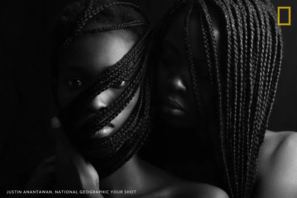 This is a photo of Haddy and Awa, two Gambian models; they represent the strength of women as family, sisters in the world. They nurture one another and unite to overcome social inequality and injustices. Awa says women in fashion modeling challenge male dominance because it is an industry where they get paid more than men, have opportunities for business, and have greater influence. She says modeling inspires her to show the world what she can do with her potential as a woman. Image by Justin Anantawan. Gambia.