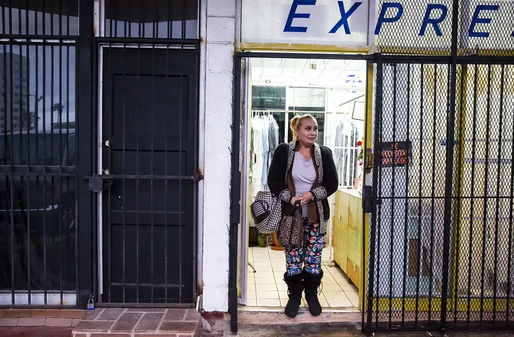 Daysi finishes her shift at a Tijuana laundry. She’ll soon transition to a new job as a custodian. Image by Erika Schultz. Mexico, 2019.