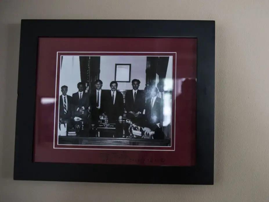 A photo from Xi Jinping's visit to the Iowa State Capitol in 1985 hangs inside the entry of U.S. Ambassador to China Terry Branstad's residence Sunday, September 24, 2017, in Beijing, China. Xi is now the president of China. Image by Kelsey Kremer. China, 2017.