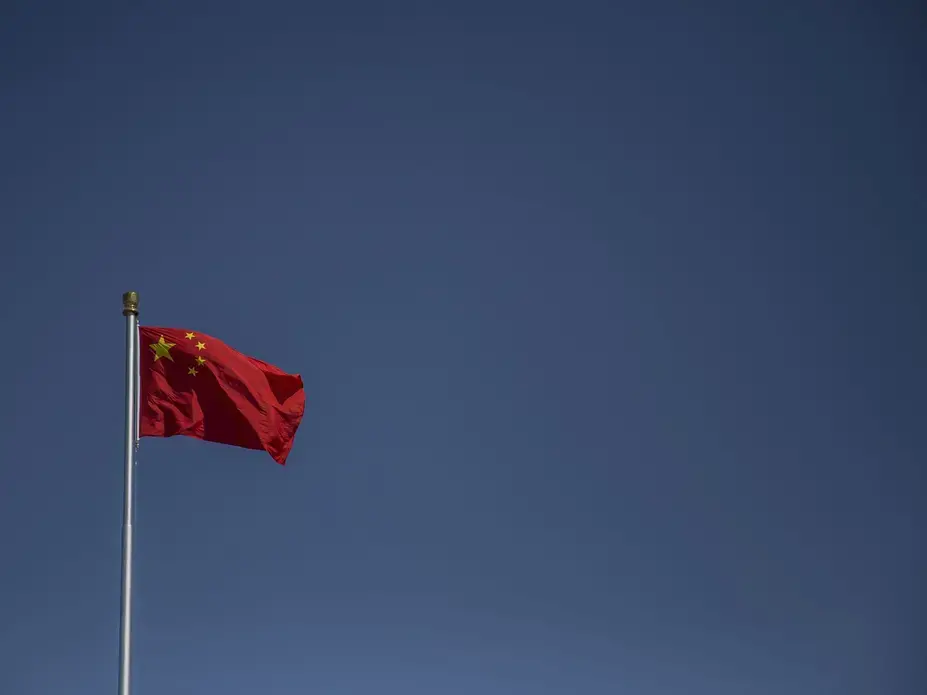 The Peoples Republic of China flag flies over Tiananmen Square on Friday, Sept. 22, 2017, in Beijing. Image by Kelsey Kremer. China, 2017.