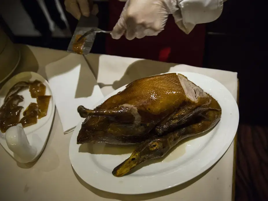 Beijing Duck, a famous preparation of duck, is served for dinner in Beijing, on Thursday, Sept. 21, 2017, in China's capital city. Image by Kelsey Kremer. China, 2017.