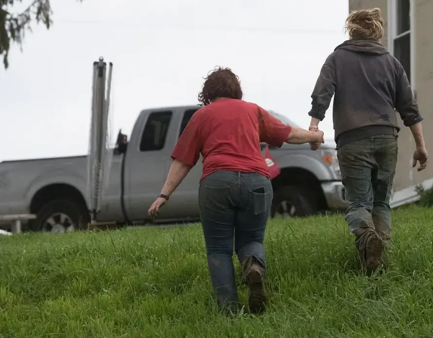 Brandi and Emily Harris walk to their truck to check on two cows that got loose while being loaded onto a trailer. Image by Mark Hoffman. United States, 2019.