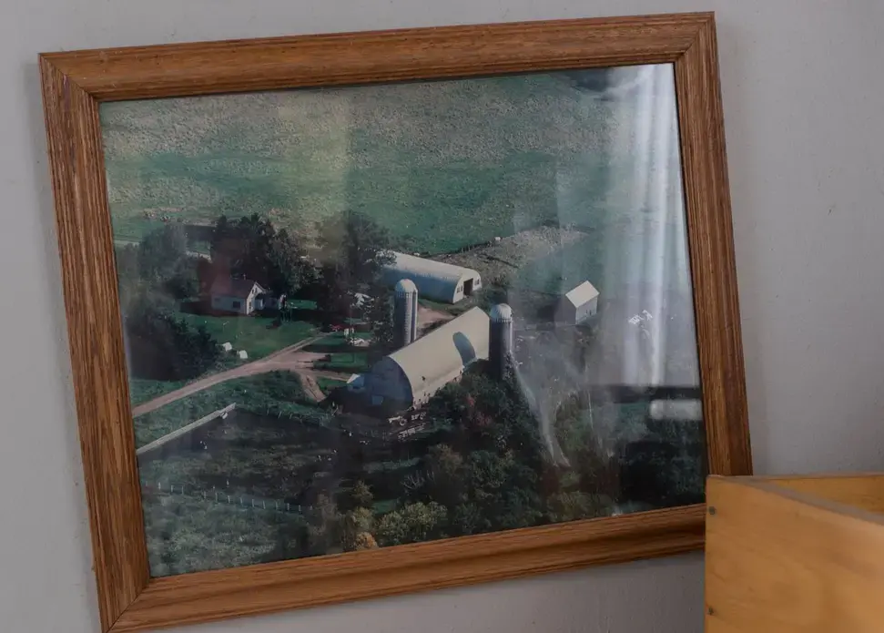 An old aerial photo still hangs in the abandoned farmhouse. Image by Mark Hoffman. United States, 2019.