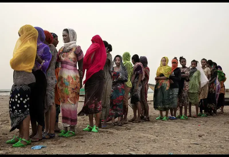 Ethiopian Tigray migrants stand in line as they are counted by smugglers after crossing the Bab el-Mandeb strait from Djibouti to the coastal village of Ras al-Ara in Lahj, Yemen, July 25, 2019. Image by AP Photo / Nariman El-Mofty. Yemen, 2019.