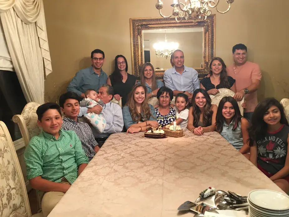 A family picture of Felix and Teresa Blanco (Teresa, center, Felix two to her left holding infant) with their three children and their grandchildren in the United States. Felix and Teresa are originally from Tarata, Bolivia, and now live in Cochabamba. Their three adult children live in the United States. While the process was challenging, Felix and Teresa were able to obtain a tourist visa to visit the United States. On being separated from his children, Felix says, “Bolivians are really affectionate. We’re always aware of our children’ activities—of our whole family. We are always in touch. No matter how far away we are, there’s always that affection, that love within the family.” Teresa added, “Of course we feel alone but I know they are always thinking about us just as we are always thinking of them. If we’re not physically untied, then we’re morally united.” Image courtesy Blanco family.