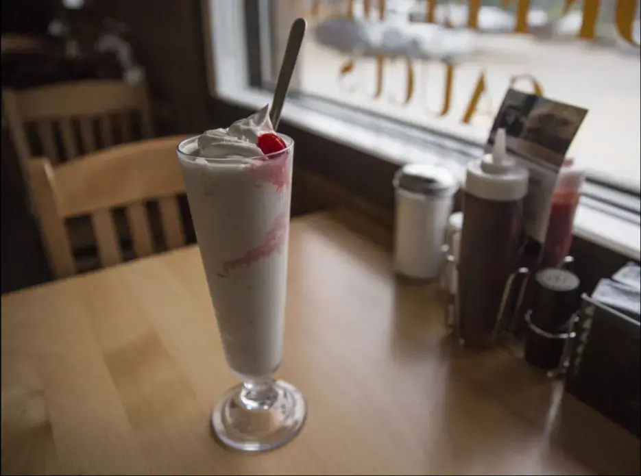 A peach pie shake is served for lunch Friday, Oct. 6, 2017, at the Hamburg Inn No. 2 on Rochester Ave in Iowa City. The pie shake is a well known menu item organically created as a way to use poorly cut slices of pie that would not be served otherwise. Image by Kelsey Kremer. United States, 2017.