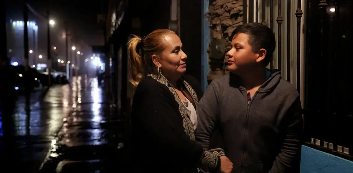 Daysi and her son Jimmy, 12, found a space together in a Tijuana shelter that provides housing to migrants, asylum-seekers and people who have been deported from the U.S. Jimmy is an American citizen by birth, but mostly grew up in Honduras. Daysi says gangs threatened them, so they fled north through Mexico. Image by Erika Schultz. Mexico, 2019.