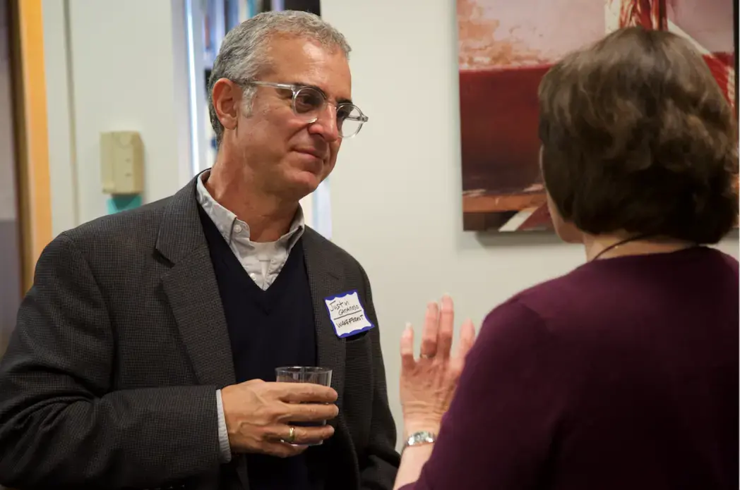 Justin Catanoso, journalism professor Wake Forest, chats with Ann Peters, university and community outreach director at the Pulitzer Center, during lunch on Friday, October 18. Image by Claire Seaton. United States, 2019.<br />
