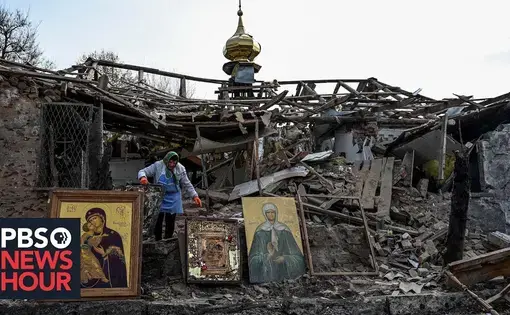 A woman sorts through the rubble of a church in Ukraine