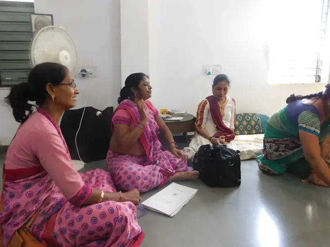 Health workers Modi Niven, Hetalben Safauki, and Harshaben Darji sit alongside Women’s Center Coordinator Zala Chandrikaben. Image by Ambar Castillo. India, 2017.</p>
<p>