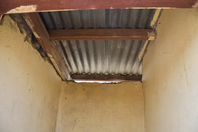 The ceiling that covers the students' pit latrine. Image by Adam Yates. South Africa, 2018.