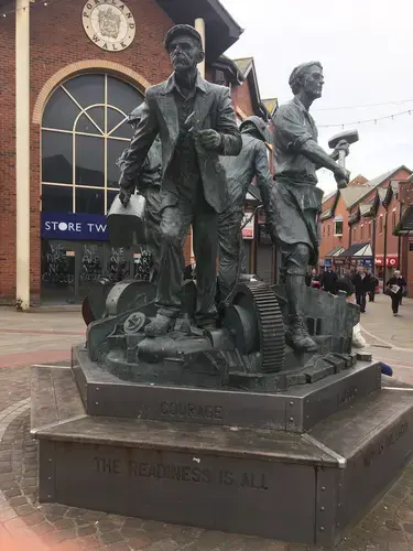 This monument to the heroic workers of the shipyard in Barrow was paid for by BAE Systems. It reads: 'COURAGE. THE READINESS IS ALL'. Image by Matt Kennard. United Kingdom, 2017.