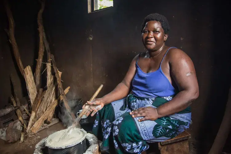 Rose Kandodo, from Nessa near Mulanje, has just finished cooking the staple food Nsima. Image by Nathalie Bertrams. Malawi, 2017.