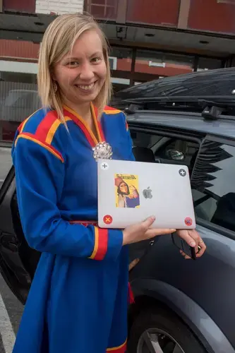 At 24, Anne Henriette Reinås Nilut is the youngest member of the Sámi Parliament of Norway. “People think that Indigenous people and Sámi people are something we read about in a history book,” she says. “But it's not.' To make her point, she shows off her MacBook laptop bearing a sticker with a Sámi version of Rosie the Riveter. Image by Amy Martin. Norway, 2018.