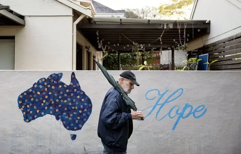 David Tonkin walks past a mural decorated with the map of Australia and the word 'Hope,' in his neighborhood in Perth, Australia, Sunday, July 21, 2019. His son, Matthew, who died from a drug overdose, hopped from clinic to clinic, collecting prescriptions for opioids and benzodiazepines, used to treat anxiety. The doctors were largely oblivious to what he was doing because Australia has no national, real-time prescription tracking system. Image by David Goldman. Australia, 2019.