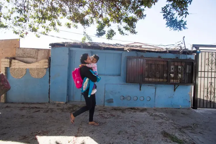 In November 2018, Rosa and her daughter Sofia walked back to the Tijuana migrant shelter after learning it wasn’t yet their turn to meet a U.S. Customs and Border Protection officer. Image by Omar Ornelas/The Desert Sun. Mexico, 2018.