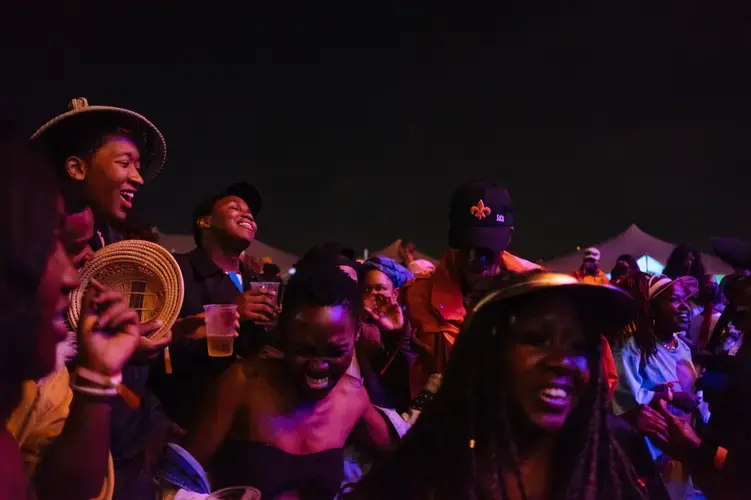 After waiting for the Afropunk Joburg festival to restart, the attendees who stuck it out in the rain are ready to keep the party going. Image by Melissa Bunni Elian. South Africa, 2017.