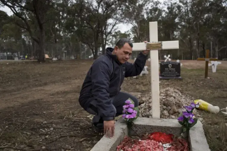 Vaea Togatuki, 48, visits the grave of his son, Junior, who died by suicide on September 11, 2015 while incarcerated in Goulburn’s Correctional Center. Image by David Maurice Smith for The New York Times. Australia, 2018.</p> <p>