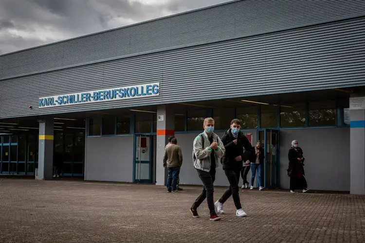 Students leave Karl-Schiller-Berufskolleg in Brühl, a secondary school outside of Cologne, Germany. Students are required by the school to wear masks on schools grounds. Image by Ryan Delaney. Germany, 2020.</p>
<p>