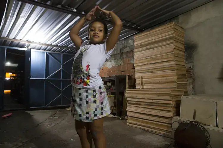 Eduarda Lopes, is shown in a photo made by her four-year-old sister, Julia, at their home in Duque de Caxias, a suburb of Rio de Janeiro in southeastern Brazil. The photo was made with the assistance of photojournalist Mark Hoffman. One way of helping to overcome language barriers and getting people to relax around a camera is to let the subjects make and see images. Image by Mark Hoffman. Brazil, 2017.