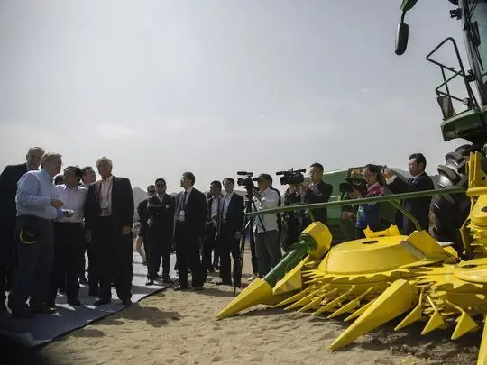 Ambassador Terry Branstad, Rick Kimberley of Maxwell, and other distinguished guests are given a tour of John Deere implements on display during the groundbreaking of the China-US Demonstration Farm on Saturday, Sept. 23, 2017, in Luanping County, Hebei, China. Image by Kelsey Kremer. China, 2017.