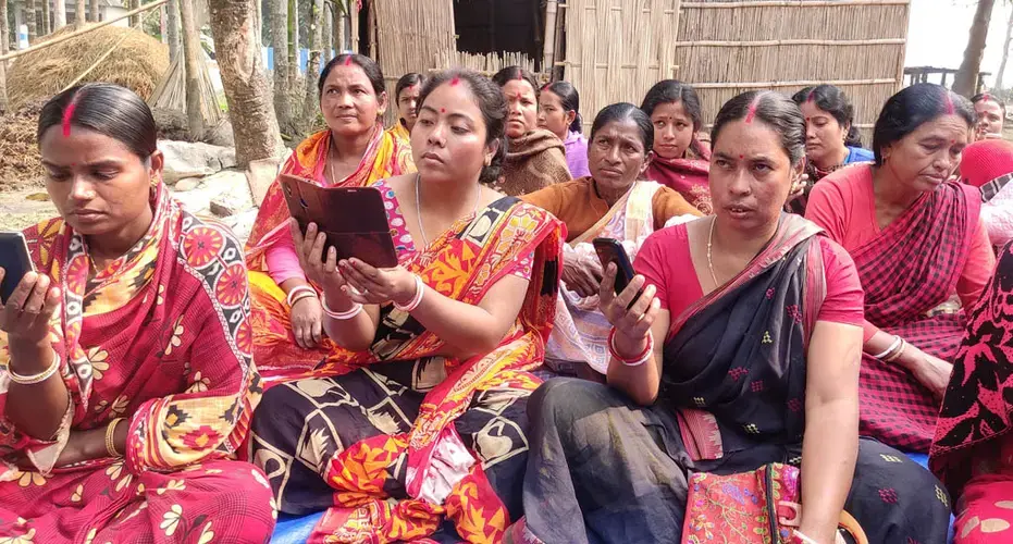 Women in the Alipurduar district of West Bengal undergoing training to access and maintain land records using their mobile phones. Image by Gurvinder Singh / VillageSquare. India, undated.