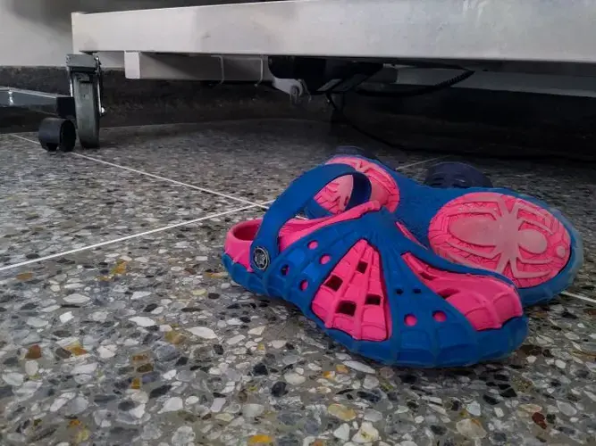 Eliécer’s colorful shoes rest on the floor under his bed at the hospitalization room in the Hospital J.M de los Ríos in Caracas. Eliécer was one of 96 patients who got a kidney transplant in Venezuela in 2015, but his body rejected the organ and the transplant ultimately failed. With his hopes placed on a kidney from a deceased donor, he now waits for a second chance at a transplant and a definitive cure to his illness. Image by Flaviana Sandoval. Venezuela, 2018.