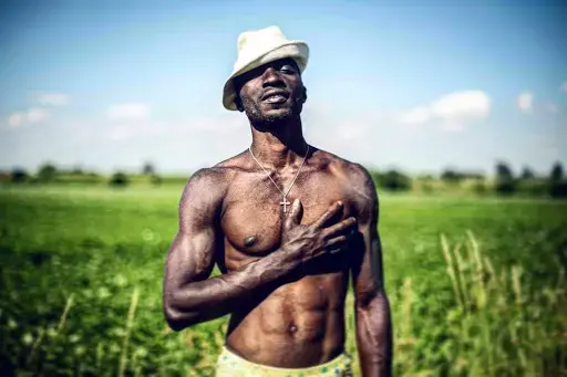 Israel, a 30-year-old Nigerian refugee poses for a portrait in the countryside of Bavaria, Germany. Image by Angelica Ekeke. Germany, 2019.