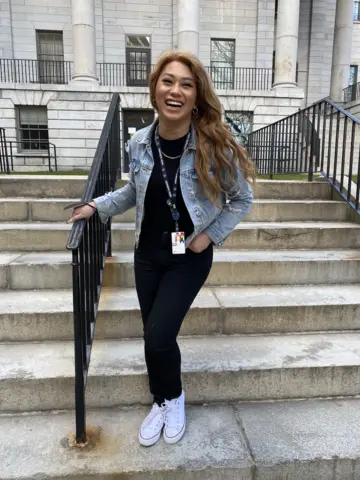 Candace Nguyen stands on hospital steps
