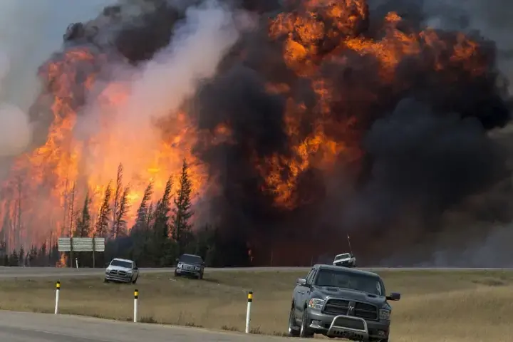 A wildfire burns near Fort McMurray, Alberta, Canada, on May 7. Image courtesy of Premier of Alberta/flickr.