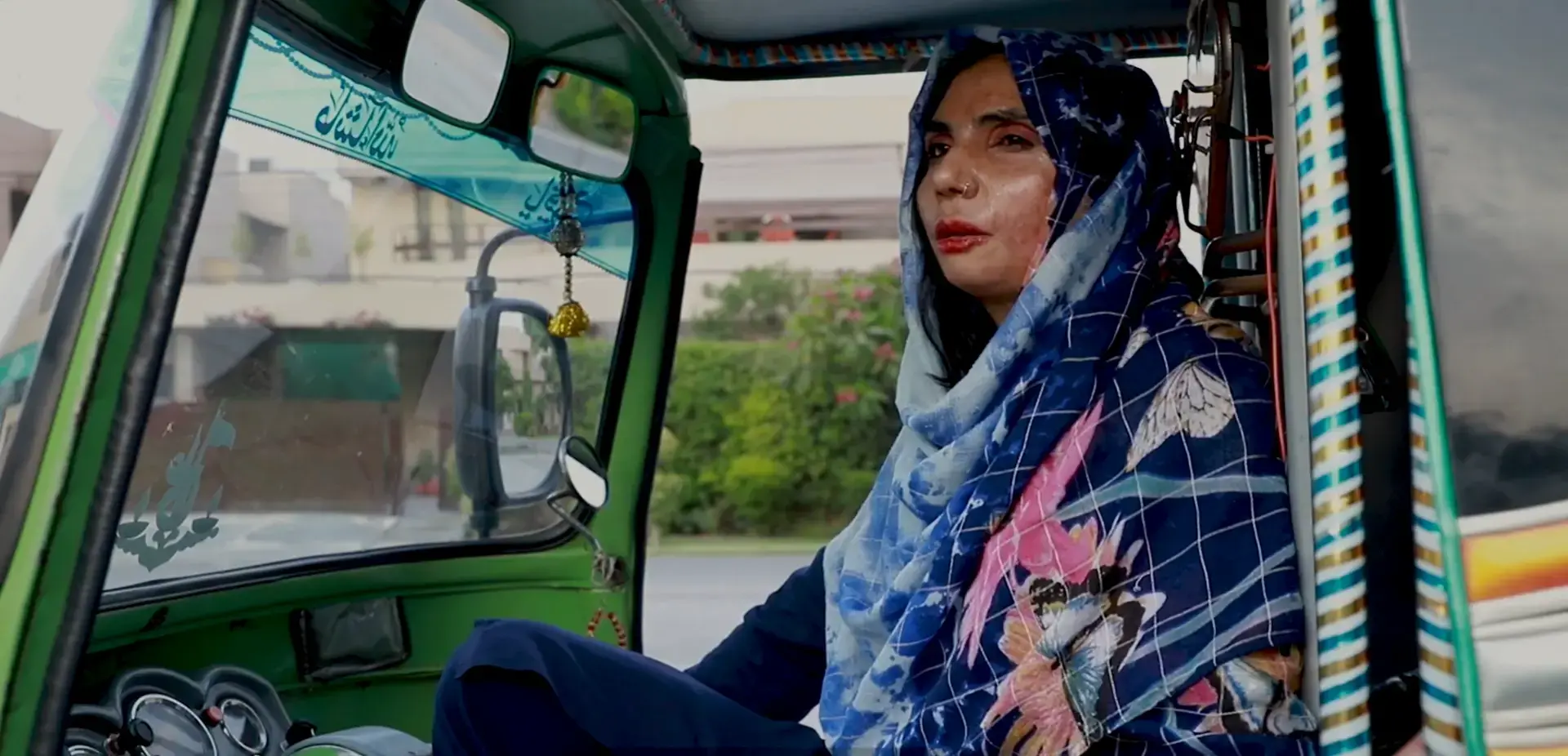 A women in the driver's seat in a rickshaw