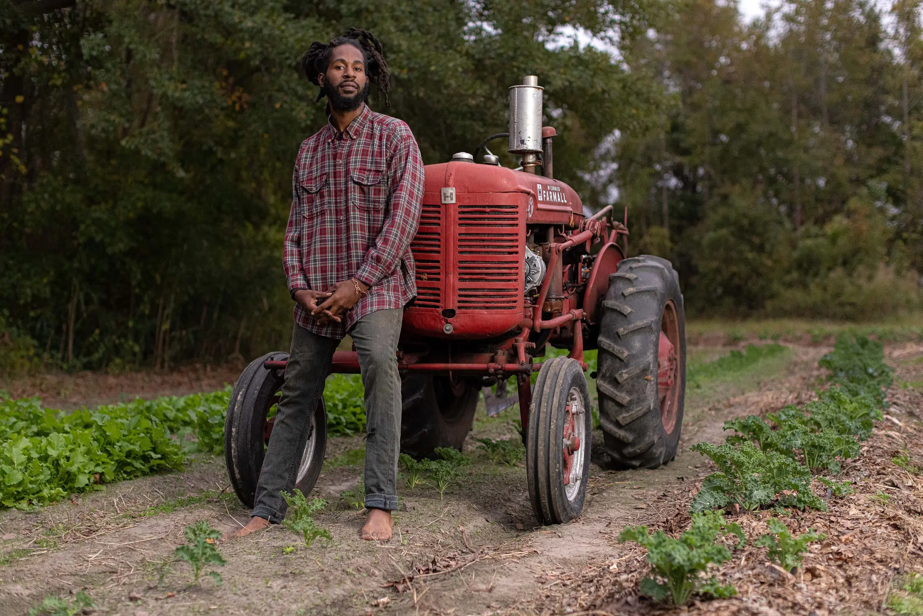 a farmer stands with his tractor
