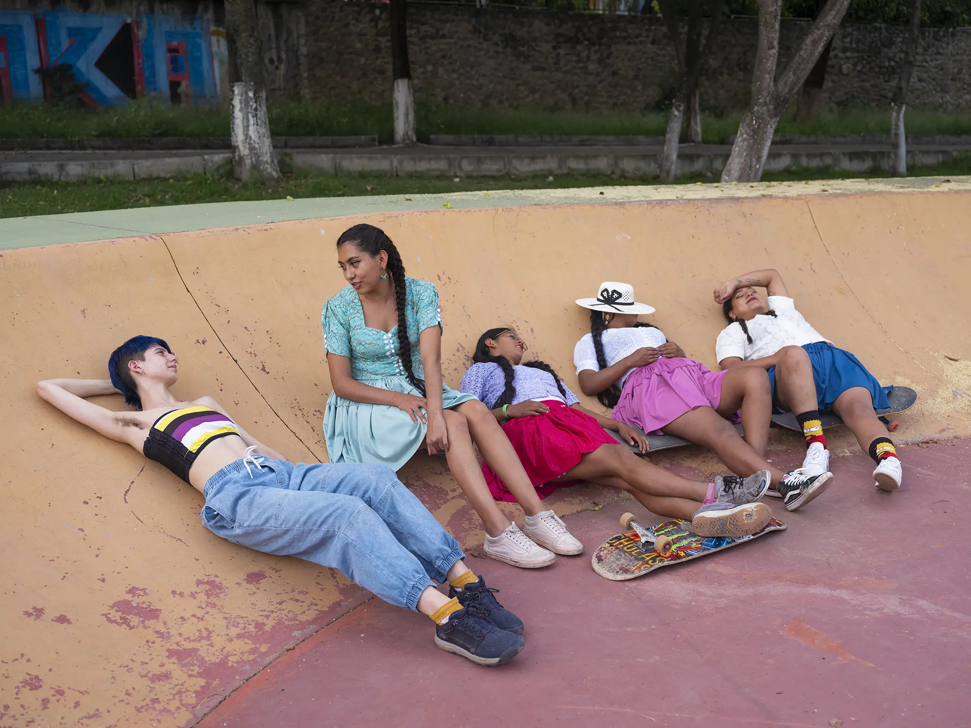 Tam lays in a skate park with young women