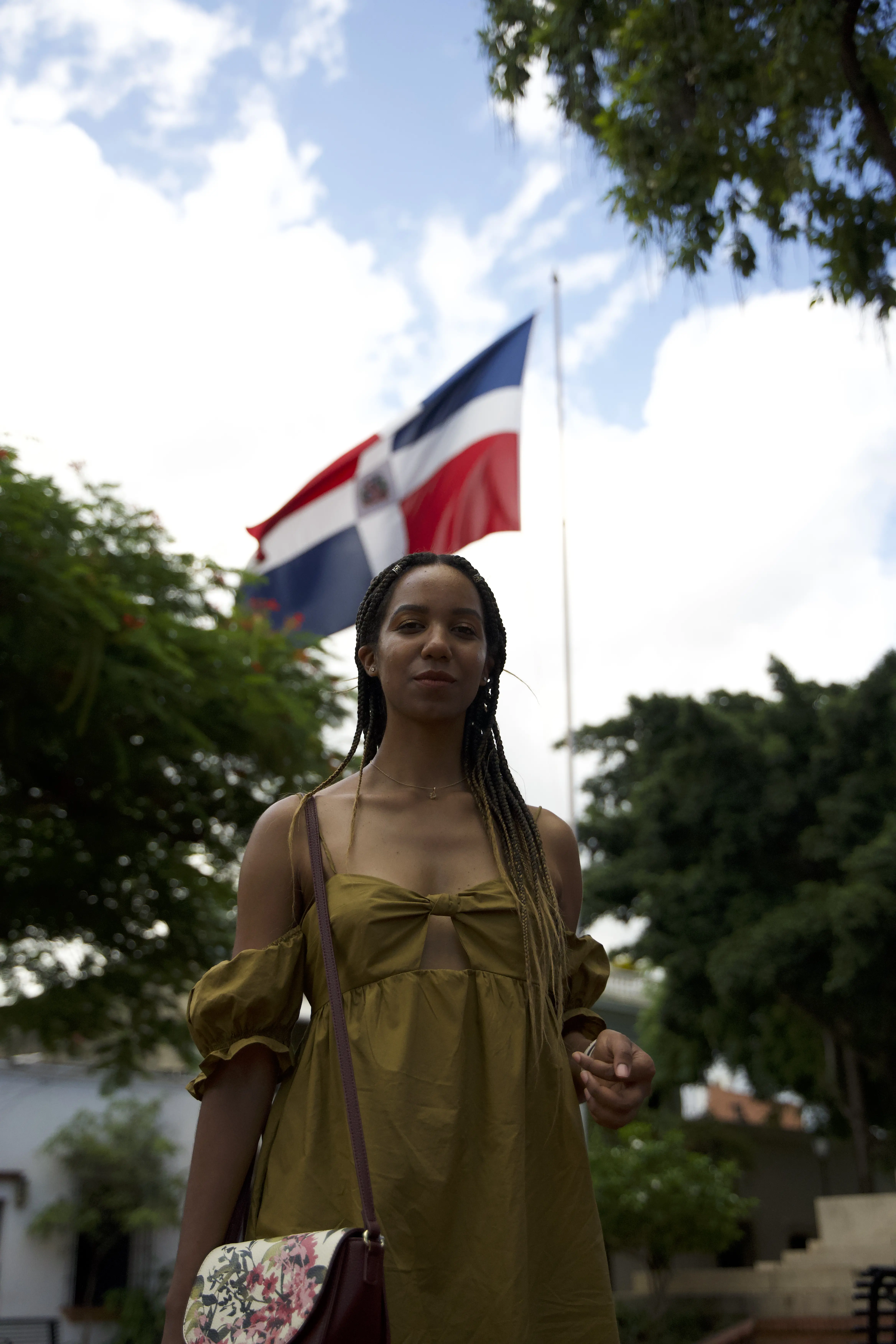 Natalia Perez-Gonzalez stands in front of the Dominican flag.