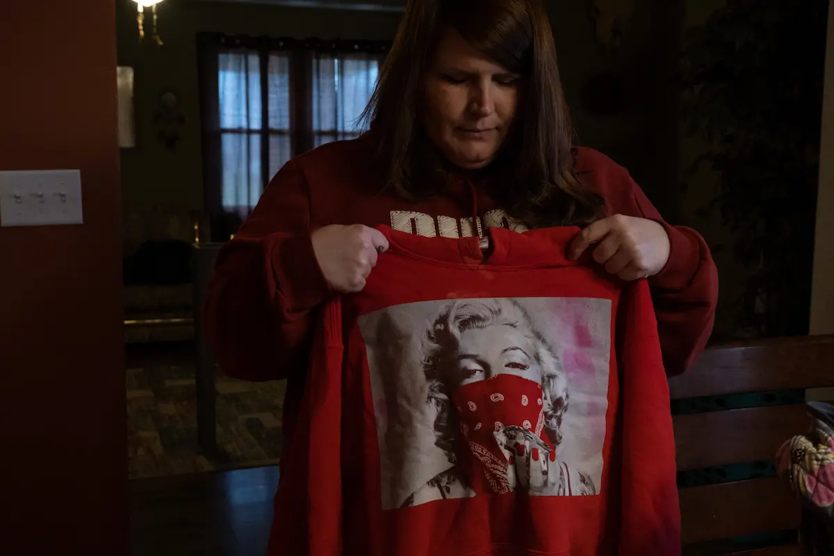 Jenny Justice holds the sweatshirt her daughter