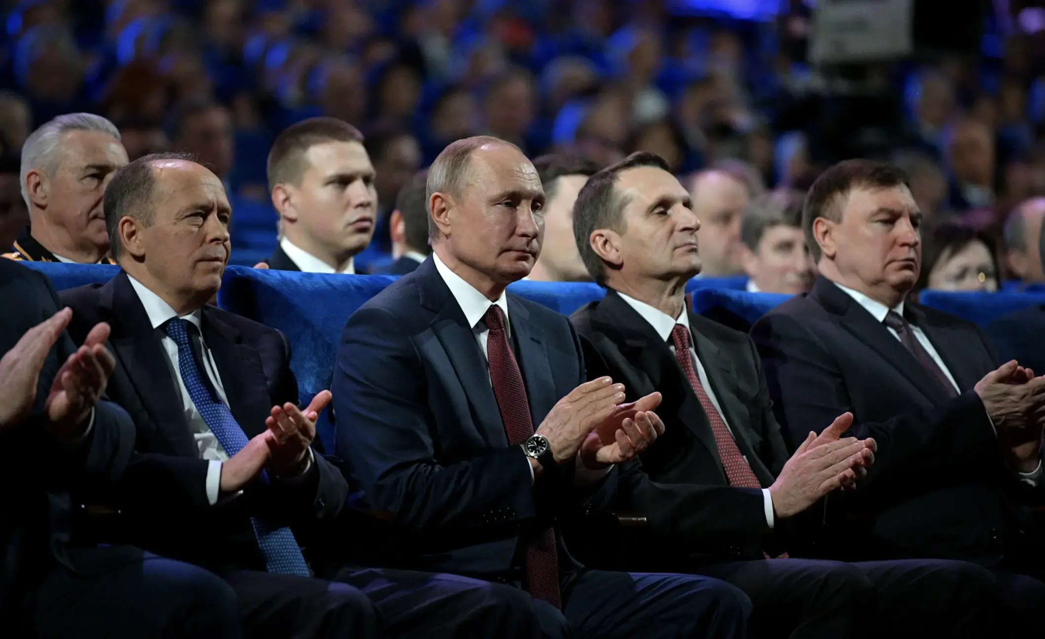 Put and members of Russia intelligence units clap together