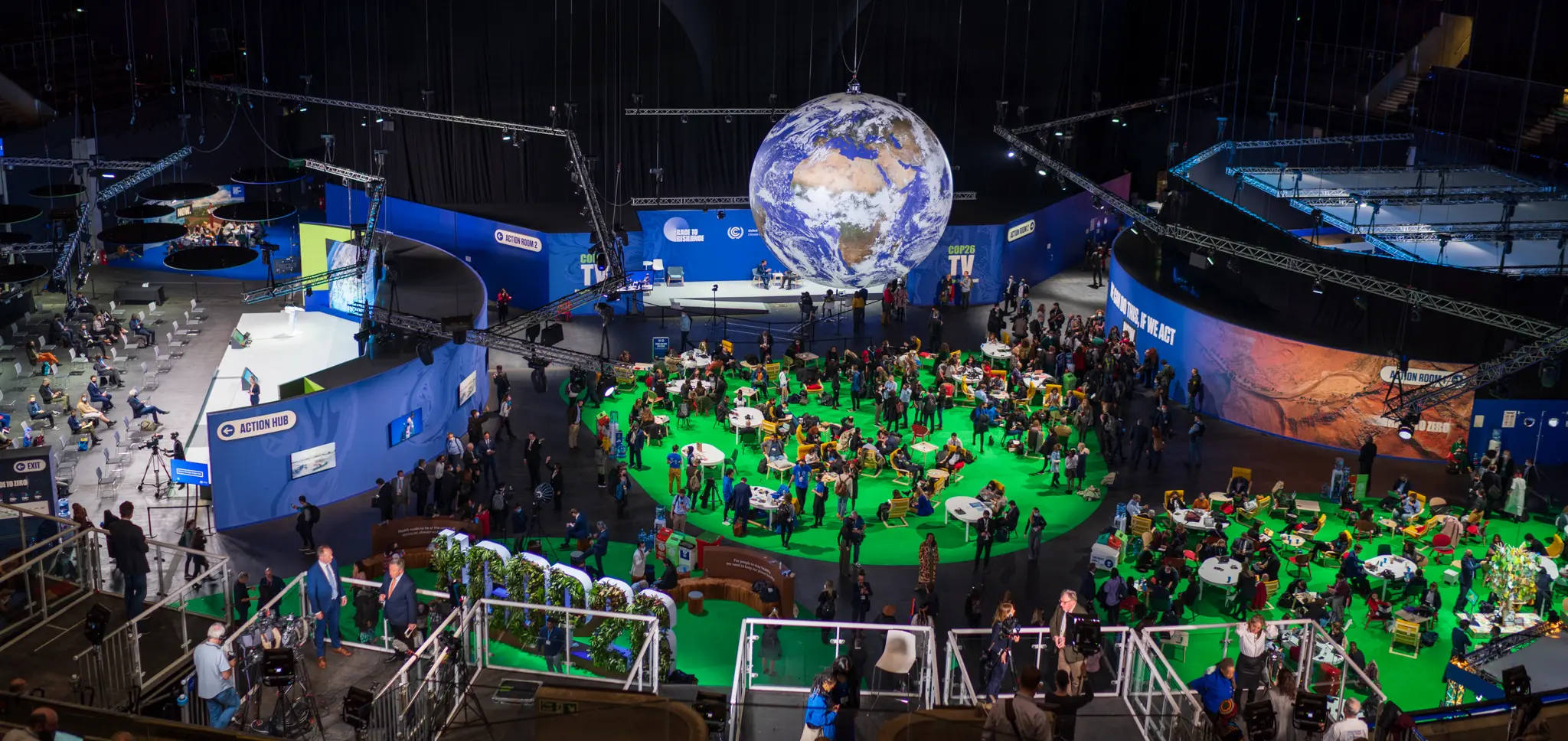 A globe rotates high above a room of the Scottish Event Center where COP26 was held.