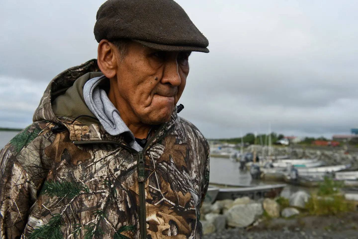Photo fo Emmonak resident in front of fishing boats