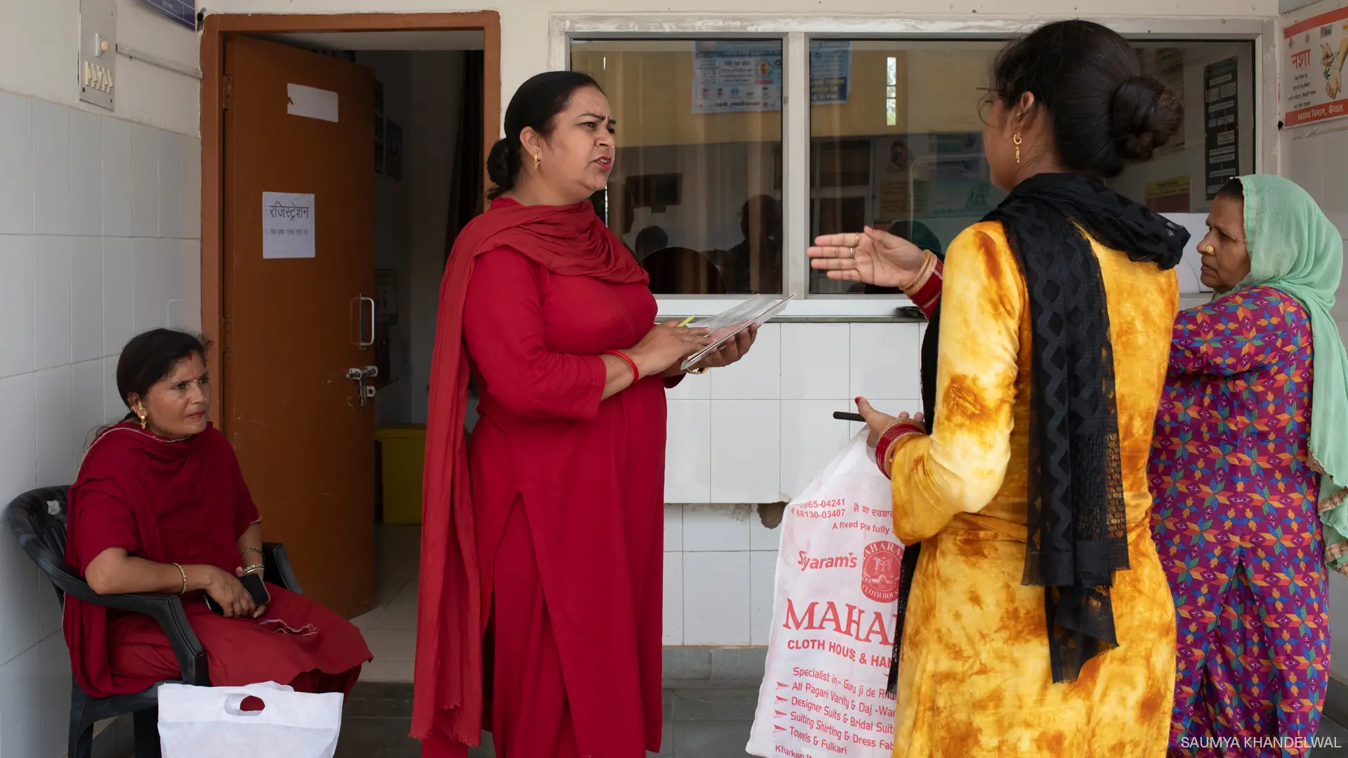 A woman directing patients at a health care center