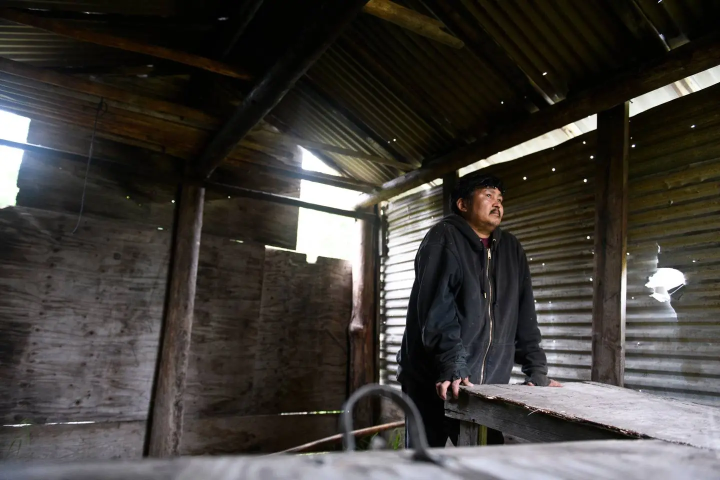 Louis Immamak, standing in his empty smokehouse in Emmonak