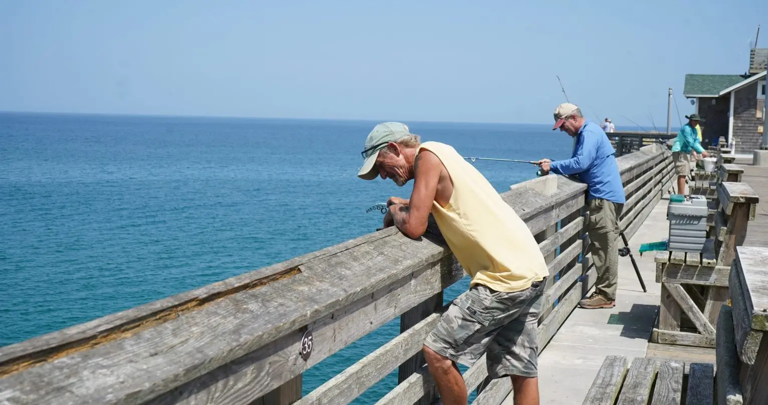 Men look out on fishing pier