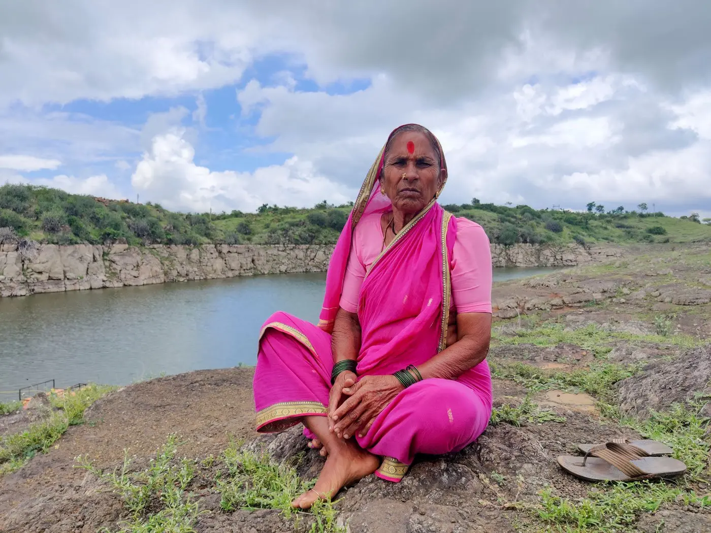 Woman sits on the bank of the river