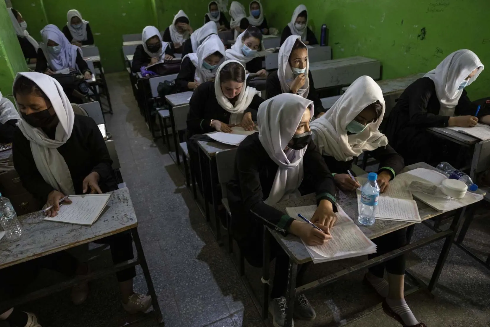 women in a school sit in class together