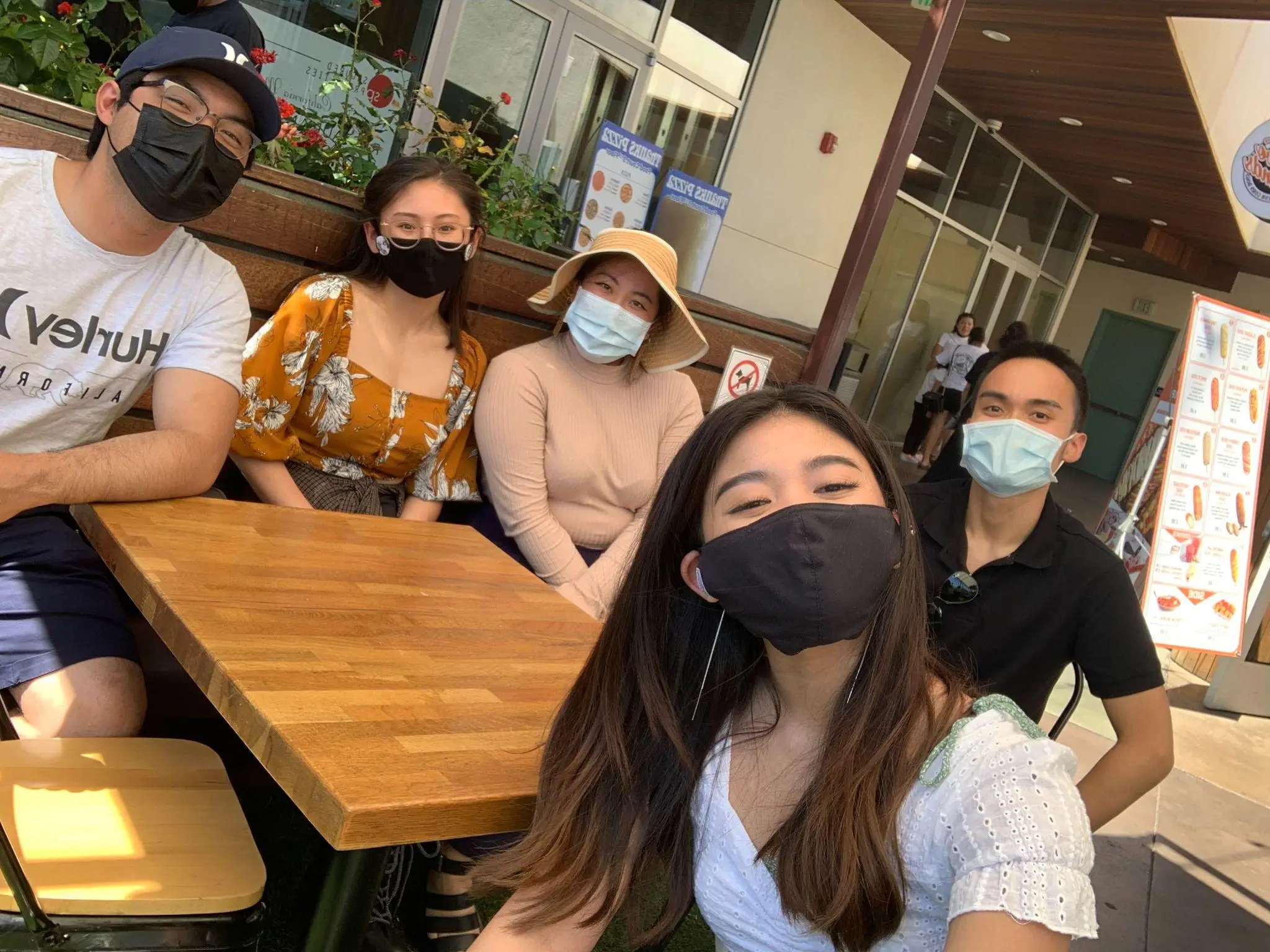 The writer and story subjects pose for a selfie while wearing masks.