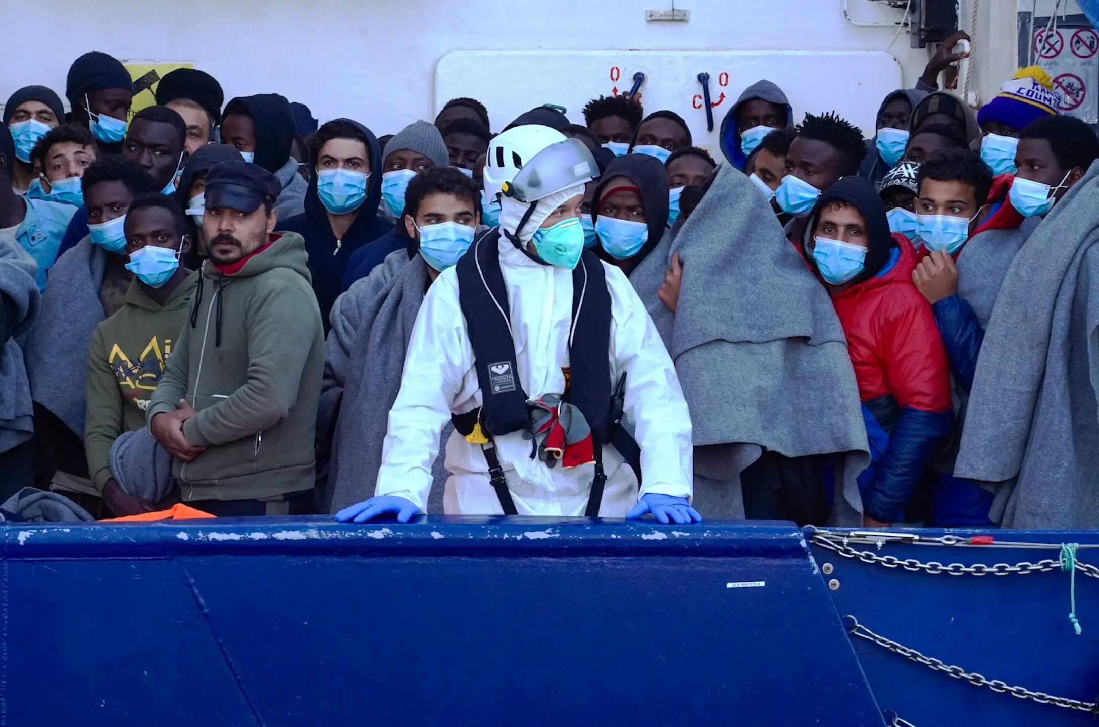 A rescue boat full of migrants waits to dock in Sicily.