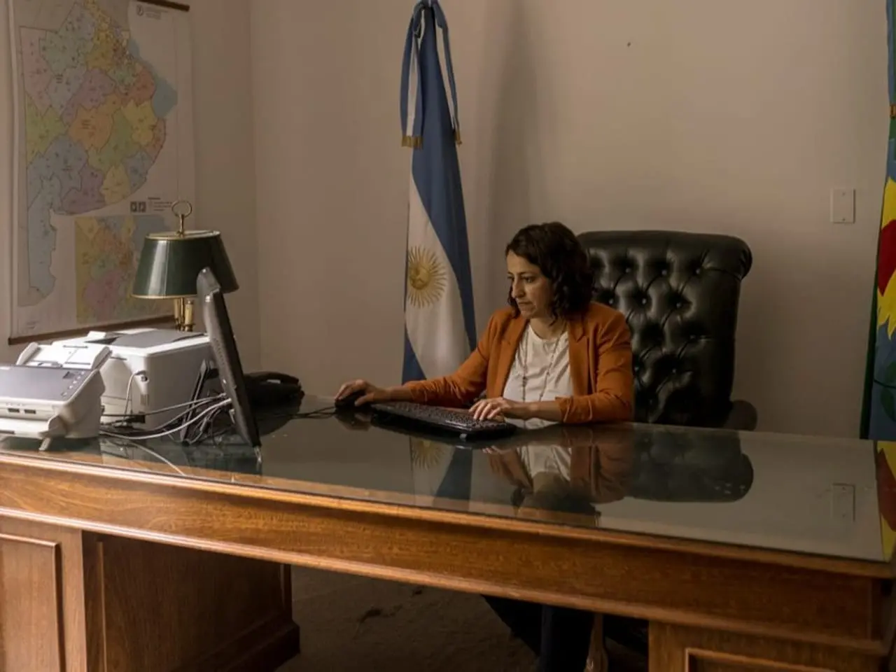 a woman sits at her desk