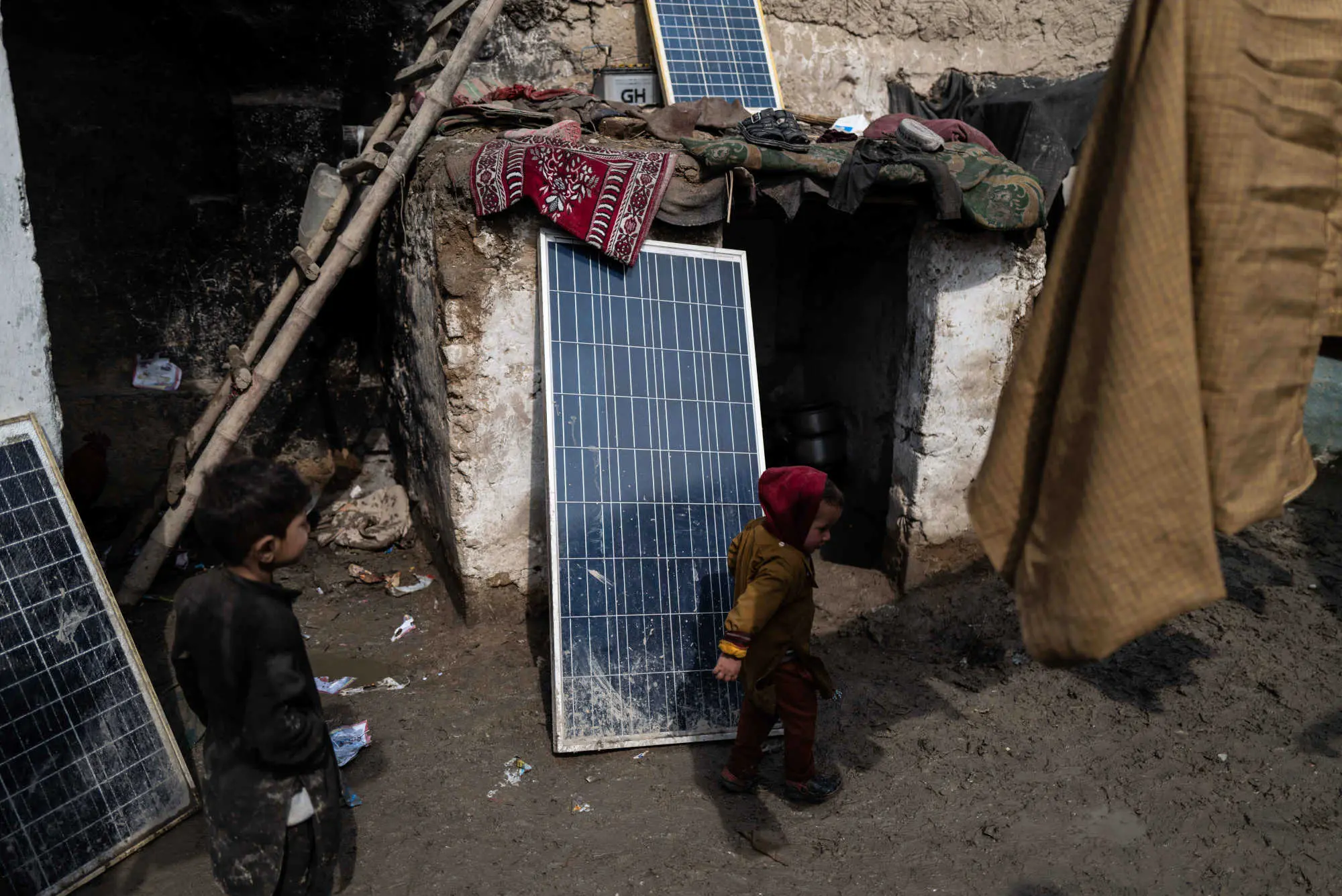 A young boy runs by the solar power panels