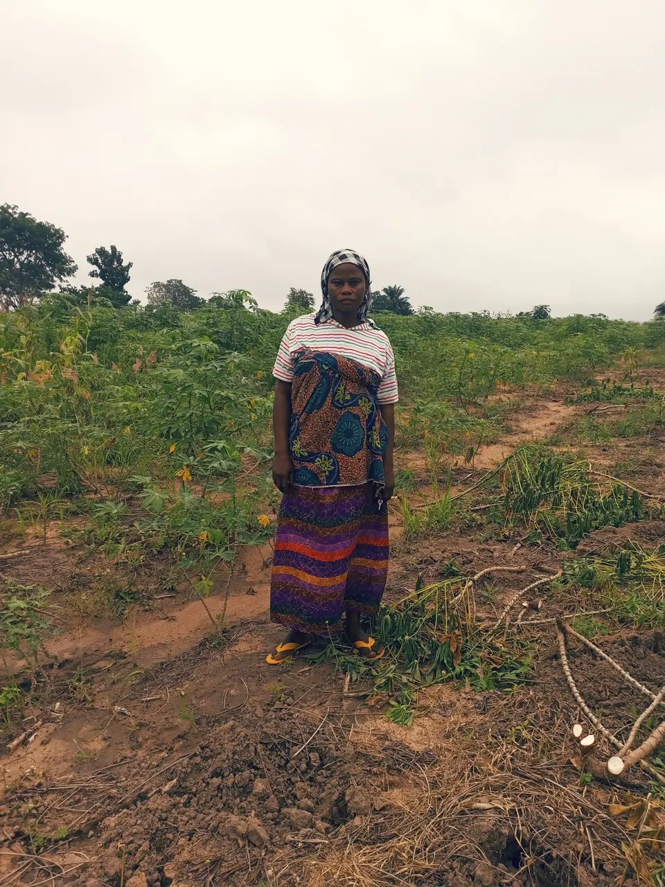 Woman stands in front of farmland