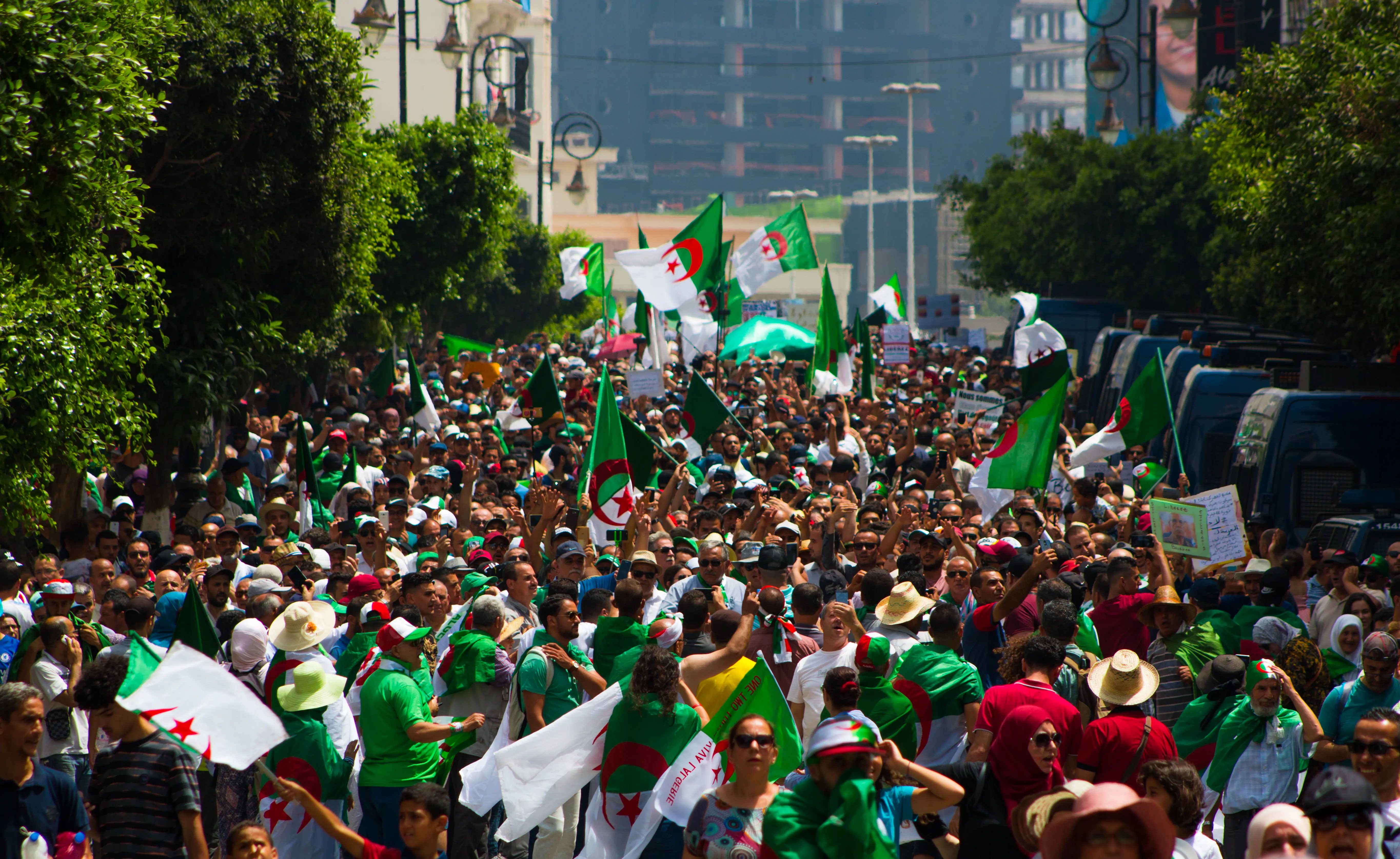 People protesting the street with Algerian flags